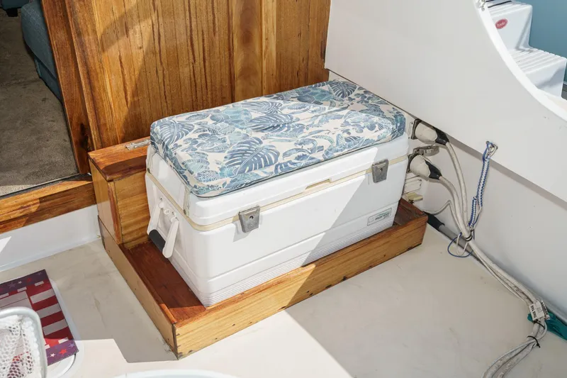 Slide: The Image of 1974 Hatteras Convertible Sportfisher interior with cushioned cooler seat and wooden accents. - 30