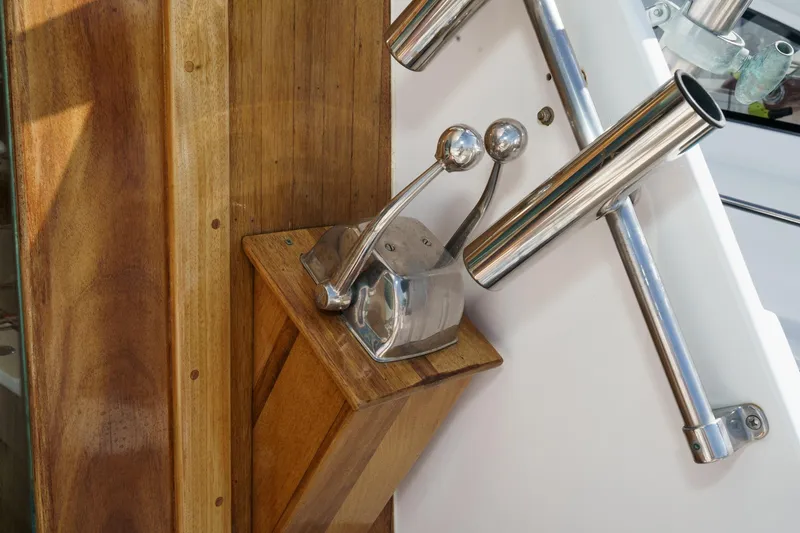Slide: The Image of 1974 Hatteras Convertible Sportfisher throttle controls on wooden panel, showcasing vintage marine design. - 31