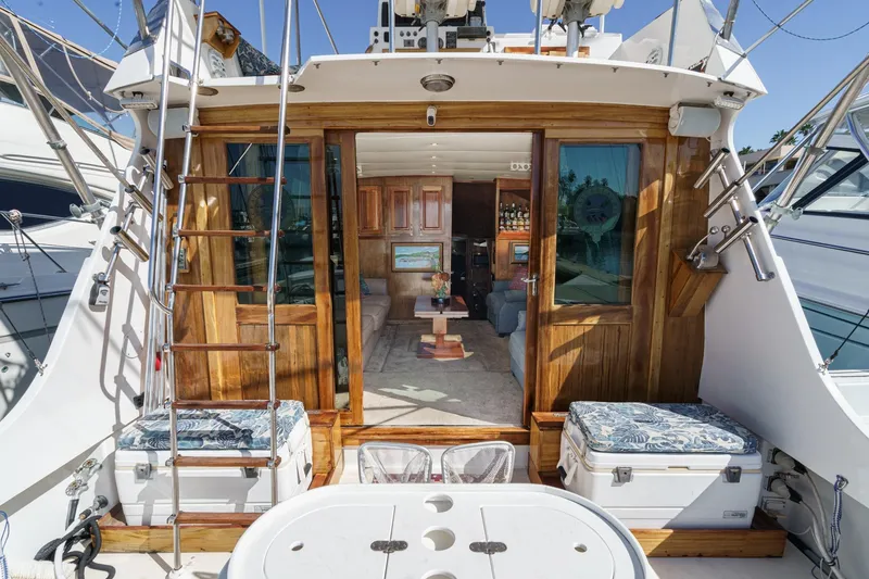 Slide: The Image of 1974 Hatteras Convertible Sportfisher yacht interior with wooden accents and seating area. - 32