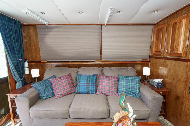 Slide: The Image of Interior of 1974 Hatteras Convertible Sportfisher with plaid cushions and wooden cabinetry. - 36
