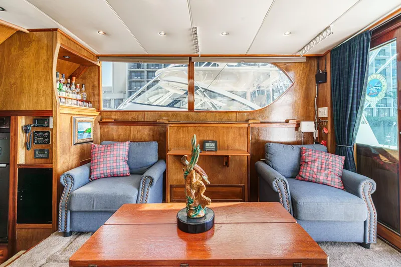 Slide: The Image of Interior of a 1974 Hatteras Convertible Sportfisher with cozy seating and nautical decor. - 37