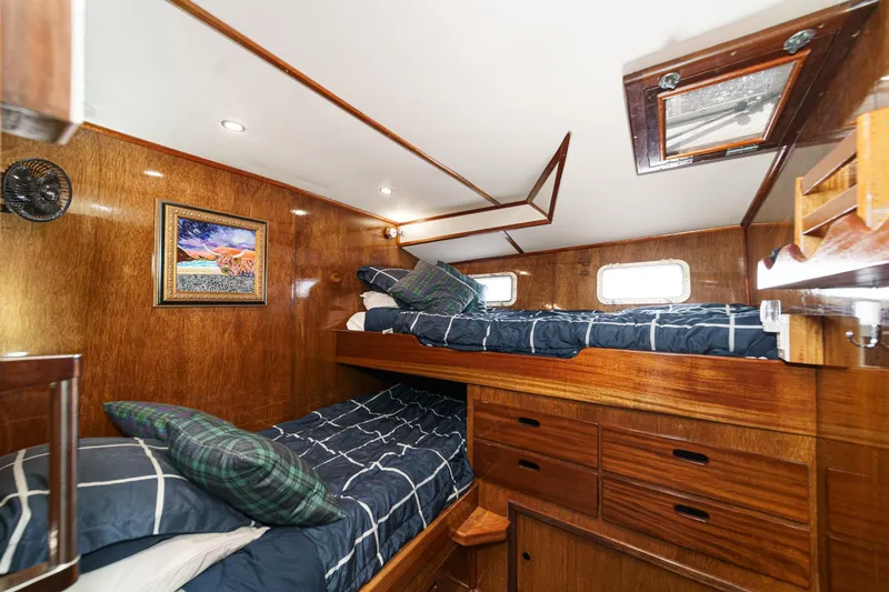 Slide: The Image of 1974 Hatteras Convertible Sportfisher cabin with wooden interior and bunk beds. - 45