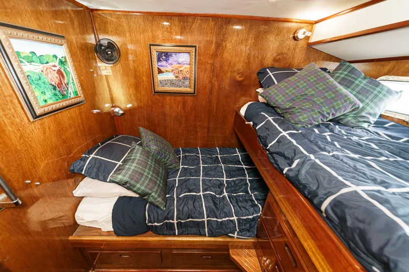 Slide: The Image of Cozy cabin interior of 1974 Hatteras Convertible Sportfisher with bunk beds and nautical decor. - 46