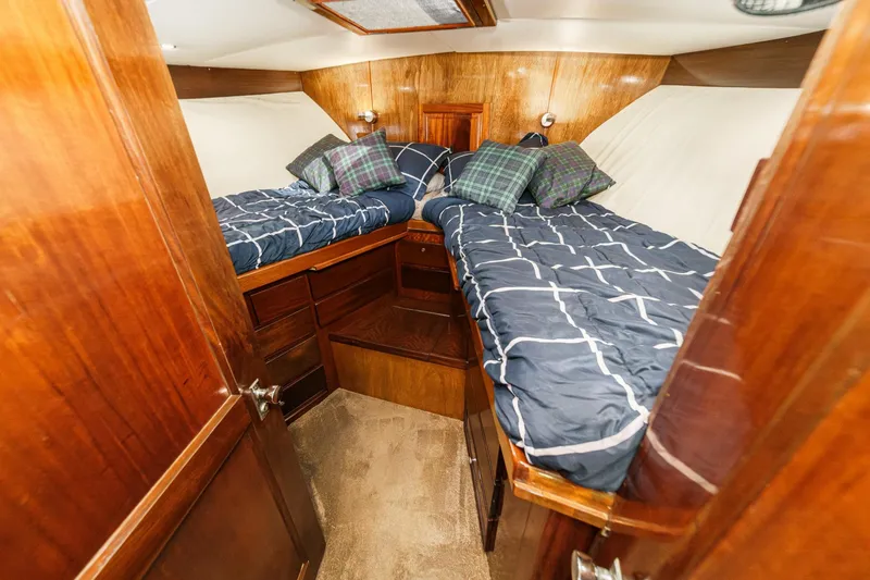 Slide: The Image of 1974 Hatteras Convertible Sportfisher cabin with twin beds and wooden interior. - 47