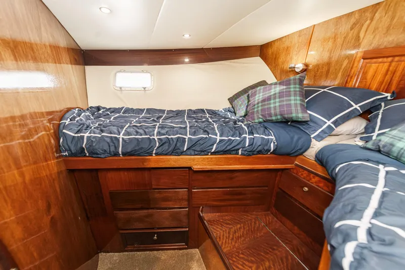 Slide: The Image of 1974 Hatteras Convertible Sportfisher cabin with wooden interior and twin beds. - 48