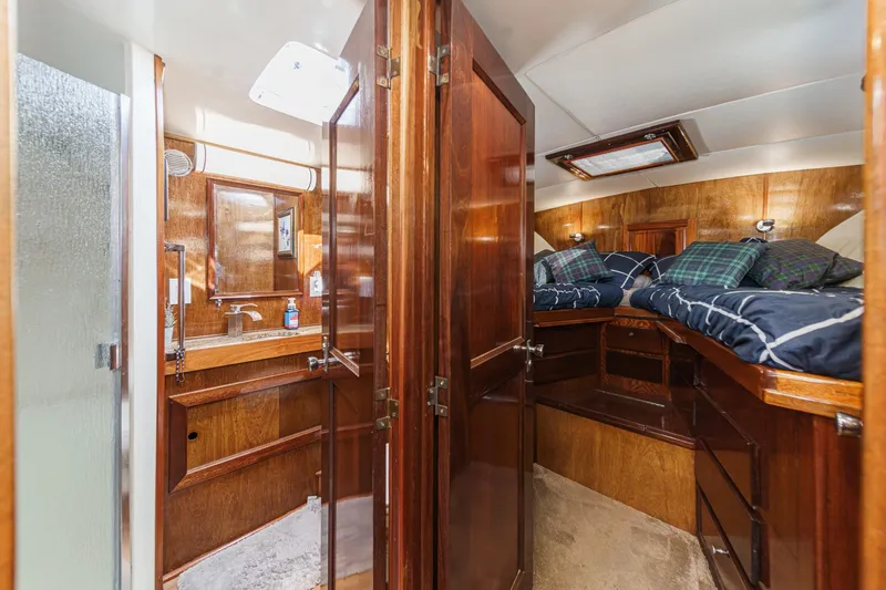 Slide: The Image of 1974 Hatteras Convertible Sportfisher cabin with wooden interior and cozy sleeping area. - 50