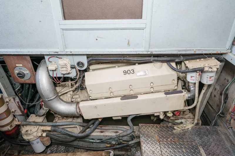 Slide: The Image of Engine room of a 1974 Hatteras Convertible Sportfisher with visible components and wiring. - 54