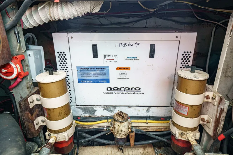 Slide: The Image of Engine room of a 1974 Hatteras Convertible Sportfisher with Norpro generator. - 58