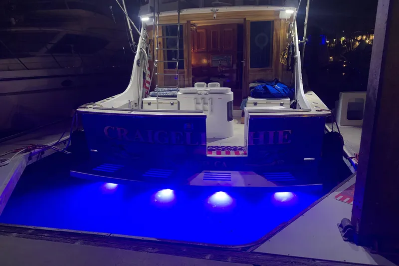 Slide: The Image of 1974 Hatteras Convertible Sportfisher with blue underwater lights at night. - 63