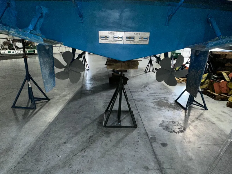 Slide: The Image of 2001 Sabreline 43 boat propellers and hull in a maintenance facility. - 10