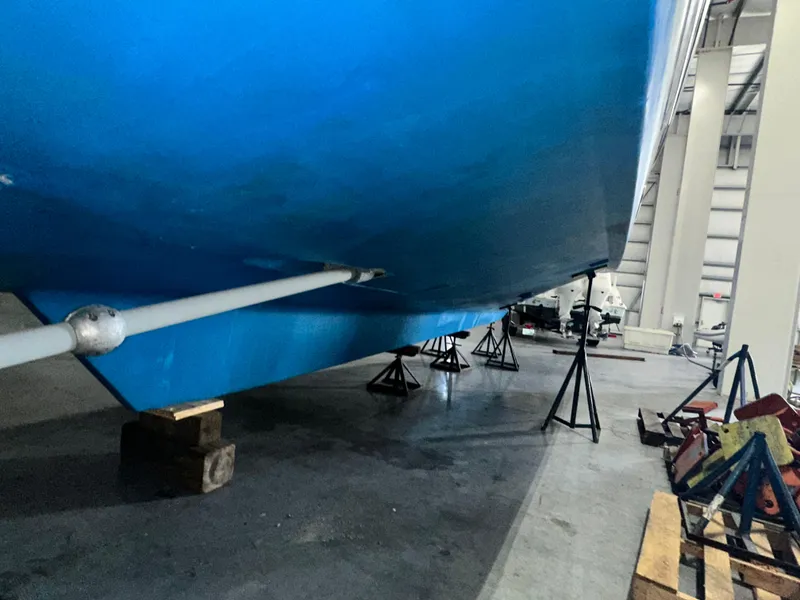 Slide: The Image of 2001 Sabre Sabreline 43 yacht hull in dry dock, supported by stands. - 11