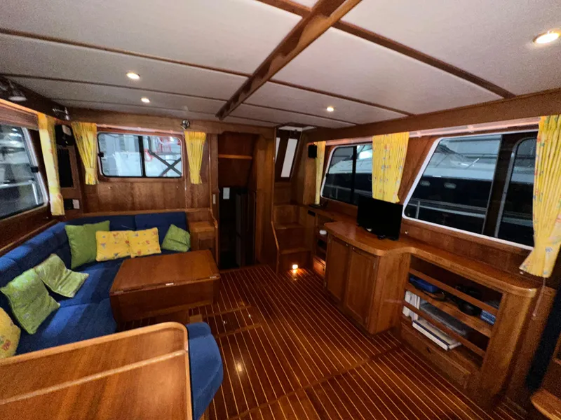 Slide: The Image of Interior of 2001 Sabre Sabreline 43 yacht with wood finish and blue seating. - 13