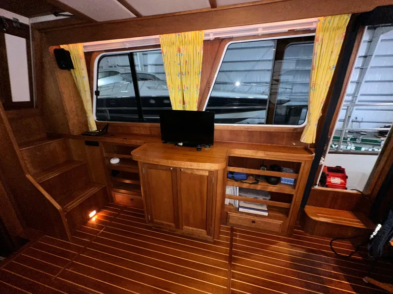 Slide: The Image of Interior of 2001 Sabreline 43 yacht with wooden cabinetry and small TV. - 14