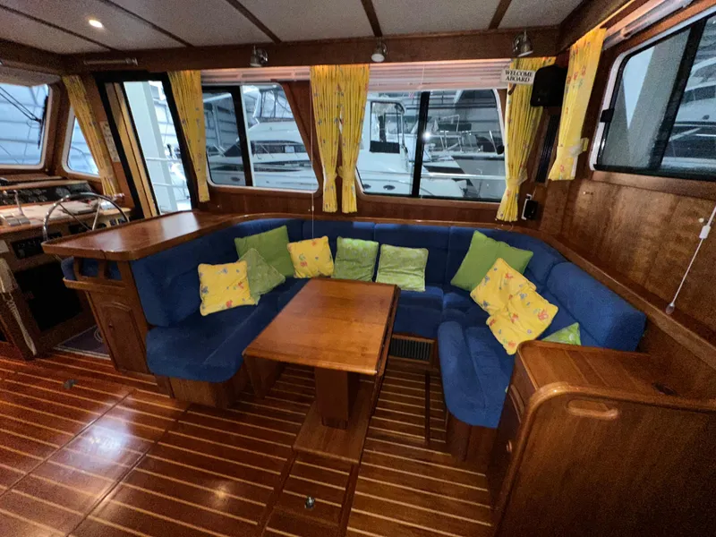 Slide: The Image of Interior of 2001 Sabre Sabreline 43 yacht with blue seating and colorful cushions. - 15