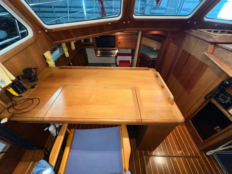 Slide: The Image of Interior of 2001 Sabreline 43 yacht with wooden table and seating area. - 17