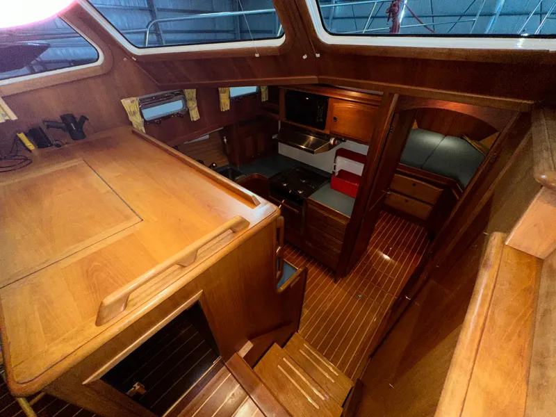 Slide: The Image of Interior of 2001 Sabreline 43 yacht with wooden cabinetry and cozy seating area. - 21