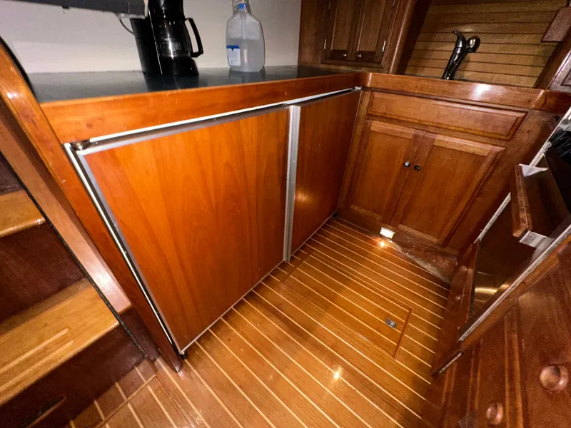Slide: The Image of Wooden interior of 2001 Sabreline 43 yacht kitchen with cabinets and flooring. - 27