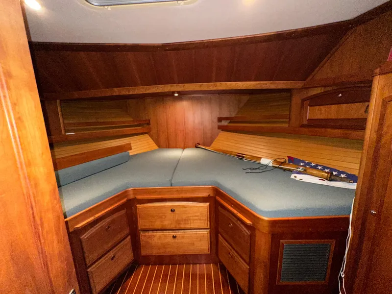 Slide: The Image of Interior cabin of 2001 Sabreline 43 yacht with wooden finish and blue bedding. - 30
