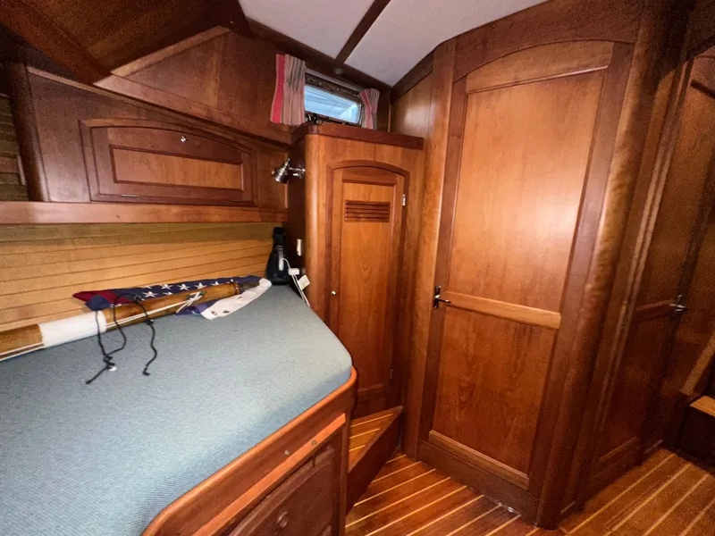 Slide: The Image of Interior of 2001 Sabreline 43 yacht with wooden cabinetry and cozy sleeping area. - 34