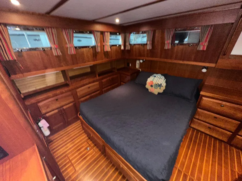 Slide: The Image of Luxurious wood-finished bedroom in 2001 Sabre Sabreline 43 yacht with cozy bedding. - 39