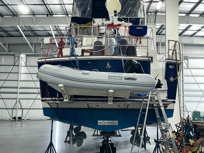 Slide: The Image of 2001 Sabreline 43 yacht in a warehouse, featuring a mounted inflatable boat. - 4