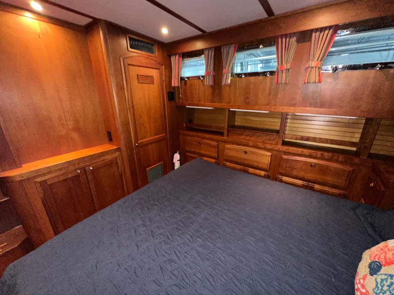 Slide: The Image of Luxurious wood-paneled bedroom in 2001 Sabre Sabreline 43 yacht with cozy bedding. - 41