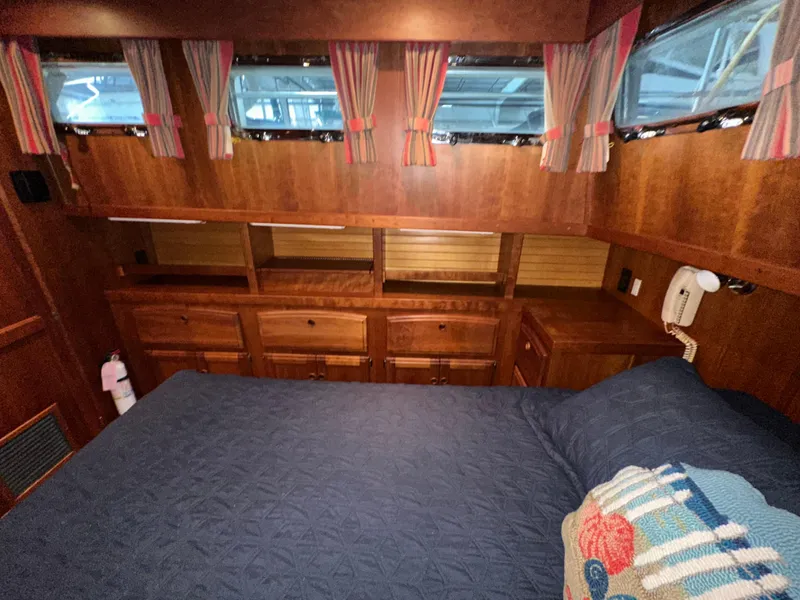Slide: The Image of Cozy cabin interior of 2001 Sabreline 43 yacht with wood finish and blue bedding. - 42