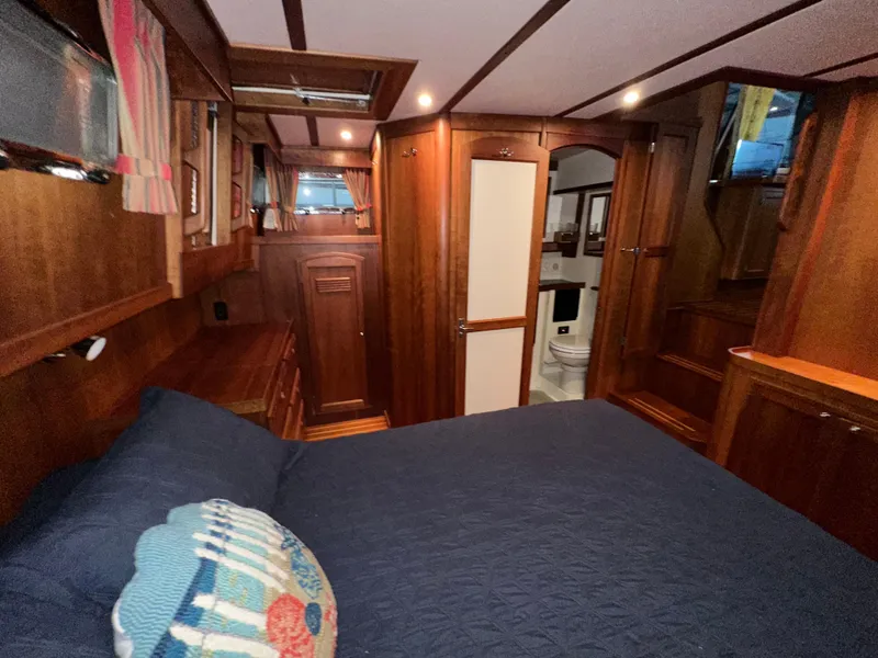 Slide: The Image of Interior of 2001 Sabre Sabreline 43 yacht with wood paneling and cozy bedroom. - 44