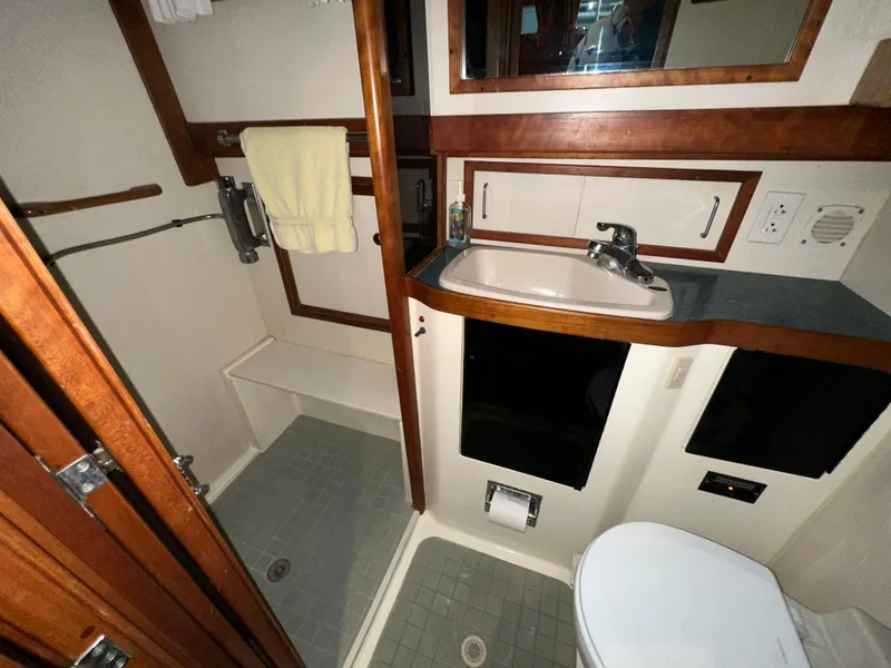Slide: The Image of 2001 Sabreline 43 yacht bathroom with shower, sink, and toilet. - 46
