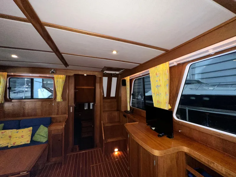 Slide: The Image of Interior of 2001 Sabreline 43 yacht with wooden finish and cozy seating area. - 48