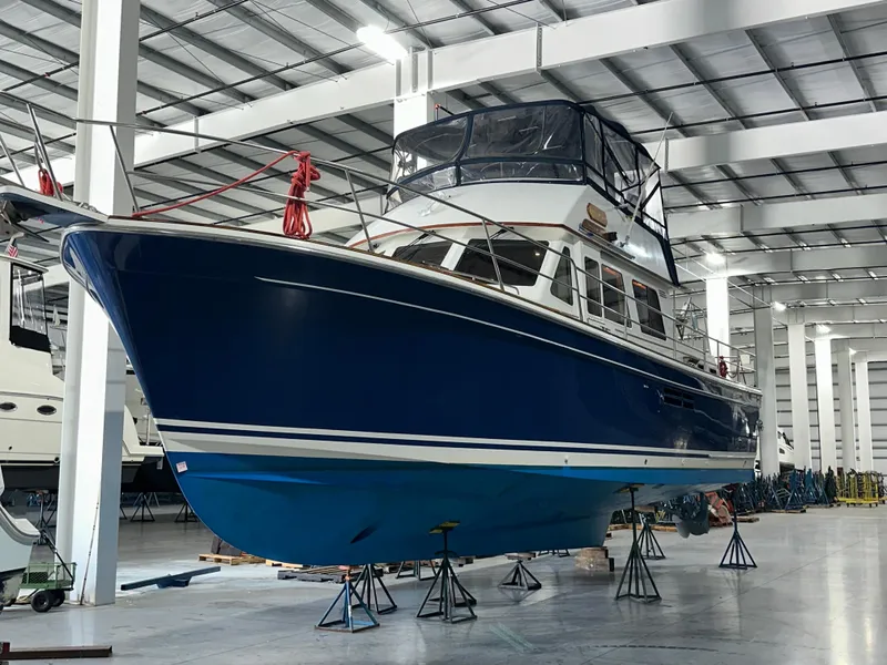 Slide: The Image of 2001 Sabreline 43 yacht in storage, blue hull, indoor facility. - 6