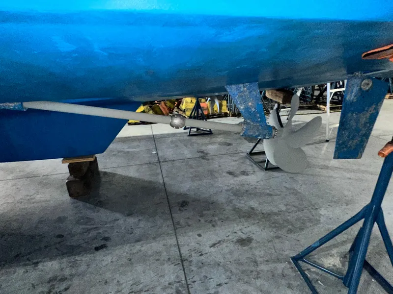 Slide: The Image of 2001 Sabre Sabreline 43 boat propeller and rudder in a workshop setting. - 9