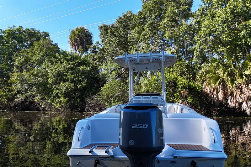 Slide: The Image of 2015 Sportsman Heritage 231 Center Console boat on a calm river, surrounded by lush greenery. - 12