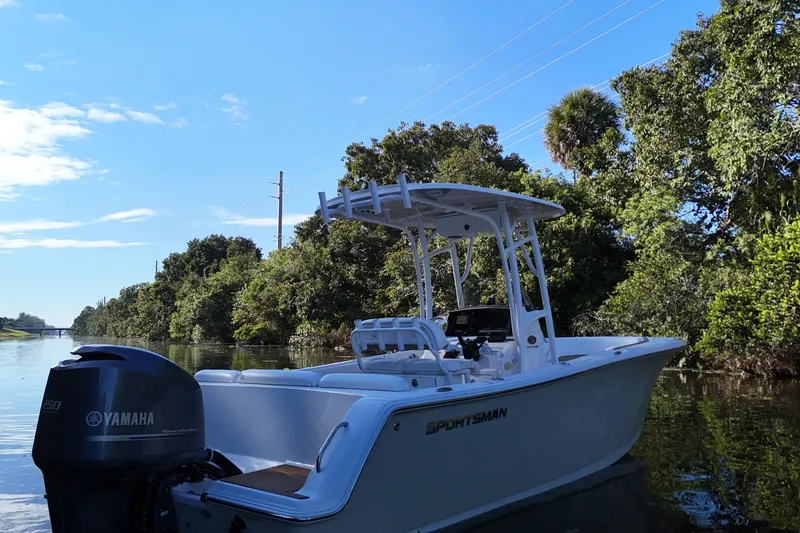 Slide: The Image of 2015 Sportsman Heritage 231 Center Console boat on a serene waterway. - 13