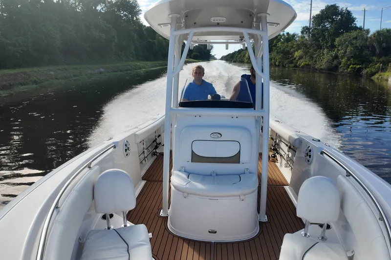 Slide: The Image of 2015 Sportsman Heritage 231 Center Console boat cruising on a scenic waterway. - 14