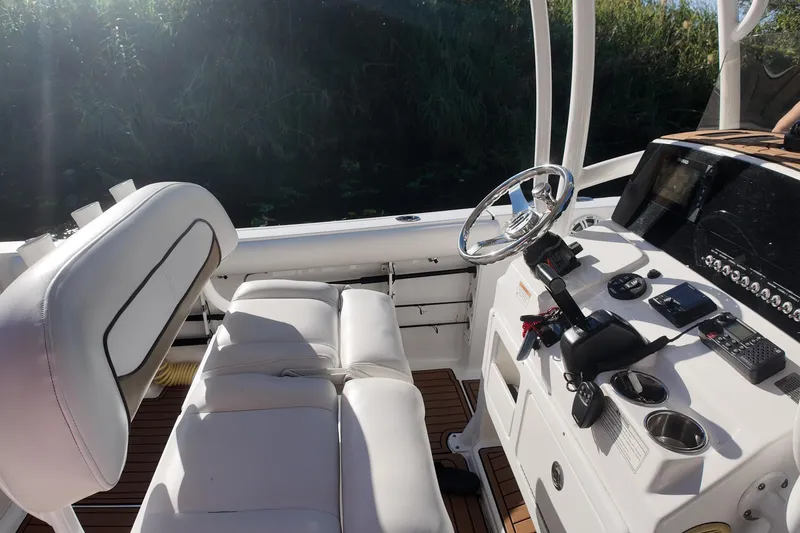 Slide: The Image of 2015 Sportsman Heritage 231 Center Console boat interior with steering wheel and controls. - 17