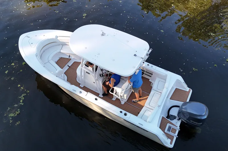 Slide: The Image of 2015 Sportsman Heritage 231 Center Console boat on water, aerial view. - 2