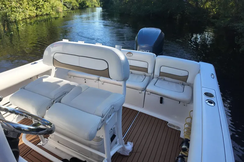 Slide: The Image of 2015 Sportsman Heritage 231 Center Console boat interior with seating and steering wheel. - 23