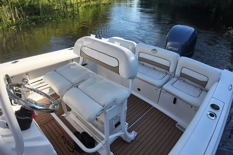 Slide: The Image of 2015 Sportsman Heritage 231 Center Console boat interior with seating and steering wheel. - 24