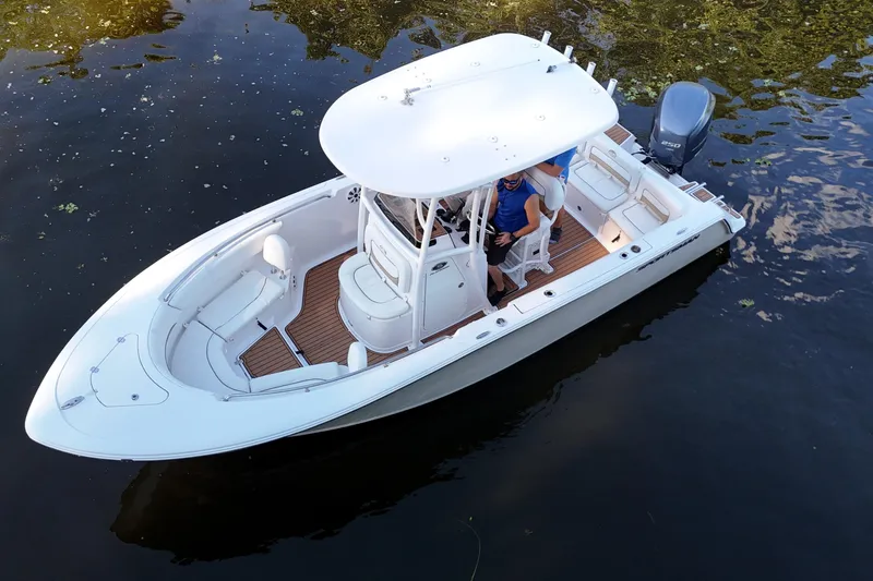 Slide: The Image of 2015 Sportsman Heritage 231 Center Console boat on calm water, aerial view. - 4
