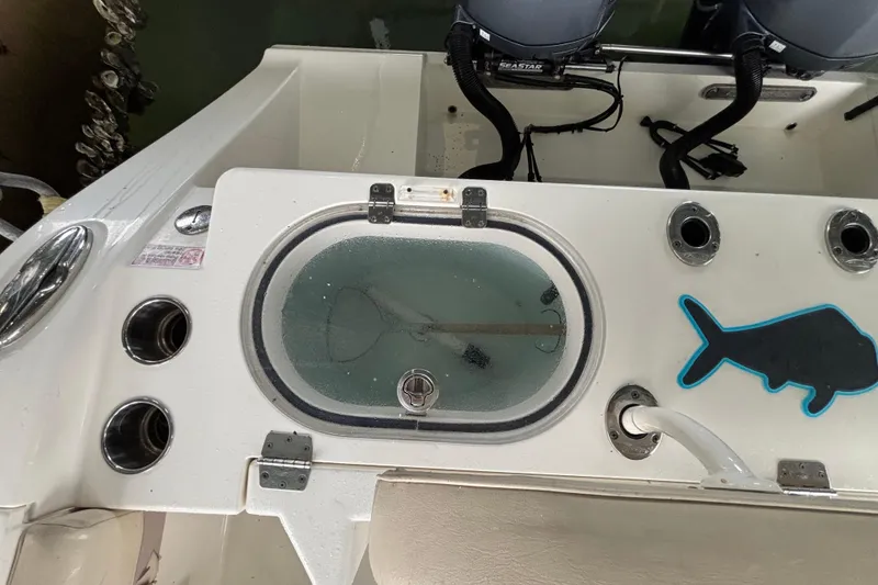 Slide: The Image of 2017 Cobia 296 Center Console boat with livewell and rod holders. - 15