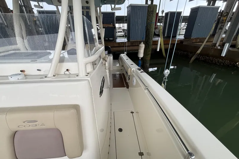 Slide: The Image of 2017 Cobia 296 Center Console boat docked in marina, side view. - 21