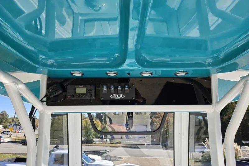 Slide: The Image of 2026 Sea Hunt Ultra 275 SE boat interior with turquoise ceiling and control panel. - 12
