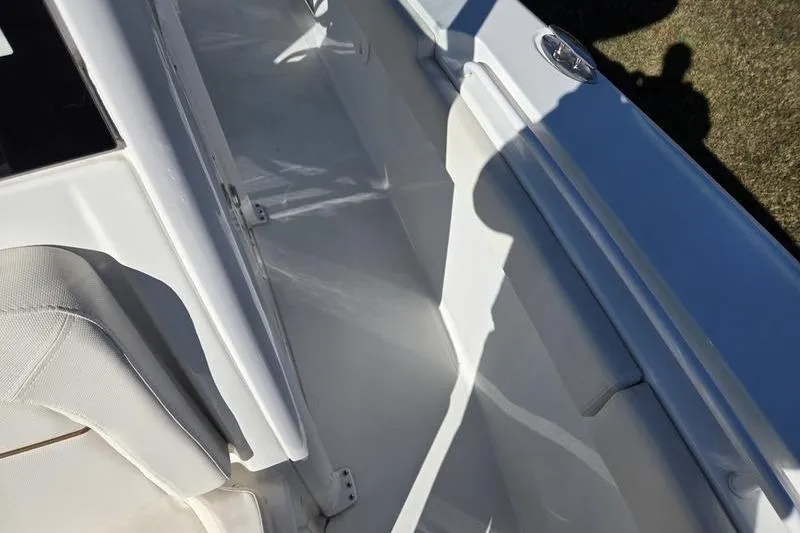 Slide: The Image of 2026 Sea Hunt Ultra 275 SE boat interior, featuring sleek white seating and deck design. - 13