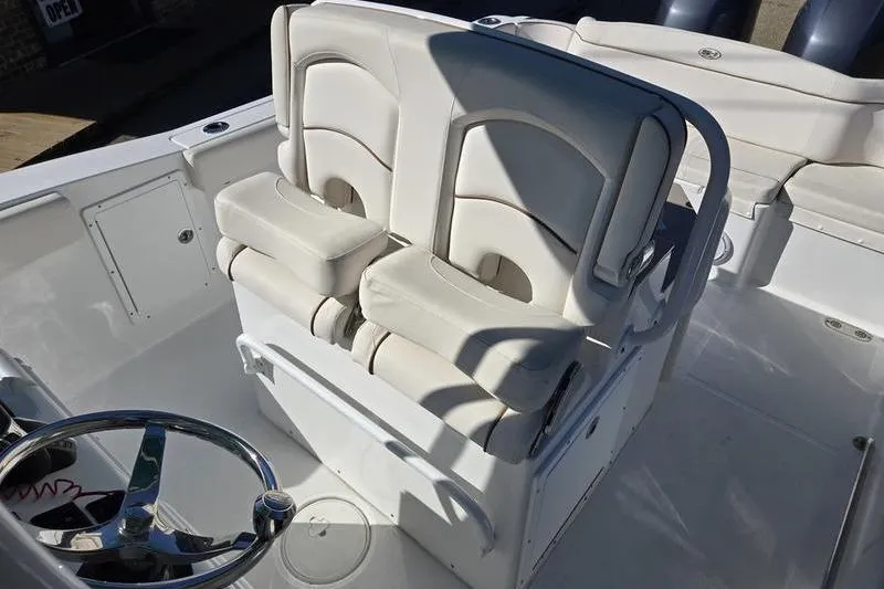 Slide: The Image of 2026 Sea Hunt Ultra 275 SE boat interior with dual white cushioned seats. - 14