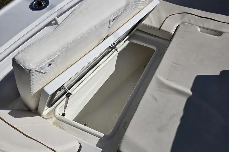 Slide: The Image of 2026 Sea Hunt Ultra 275 SE boat storage compartment with cushioned seating. - 7
