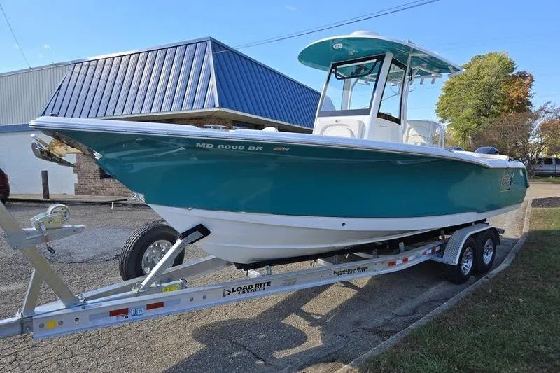 Slide: The Image of 2026 Sea Hunt Ultra 275 SE boat on trailer, parked outdoors. - 9