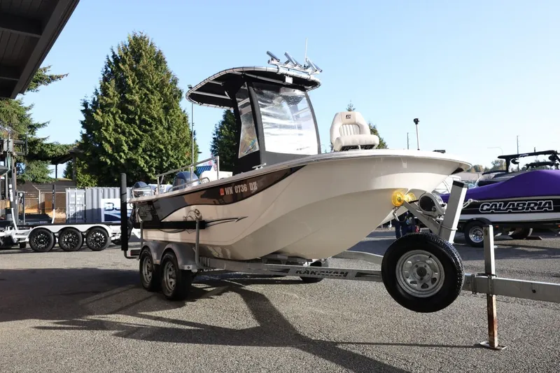 Slide: The Image of 2013 Carolina Skiff 178 DLV boat on trailer, parked outdoors. - 10