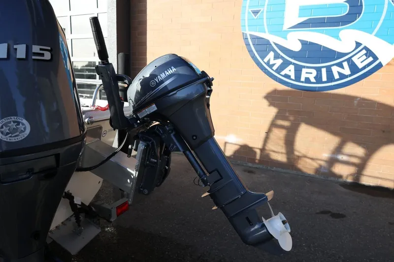 Slide: The Image of 2013 Carolina Skiff 178 DLV with Yamaha outboard motor at marine dealership. - 15