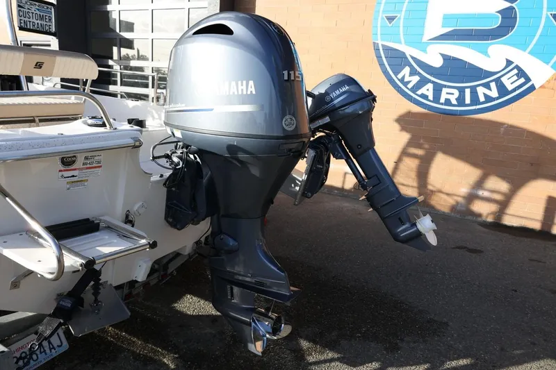 Slide: The Image of 2013 Carolina Skiff 178 DLV with Yamaha outboard motors at a marine dealership. - 16